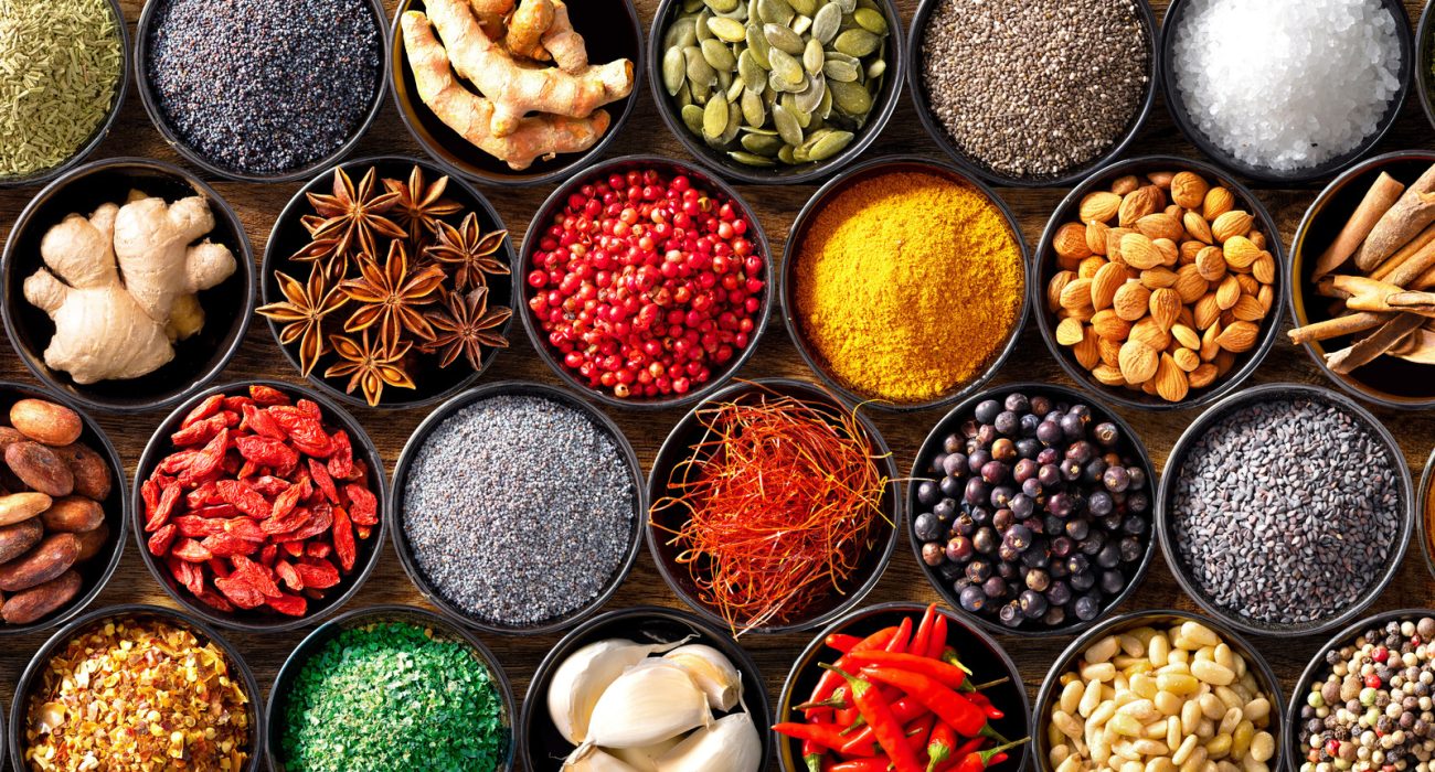 Colourful background from various herbs and spices for cooking in bowls. Top view