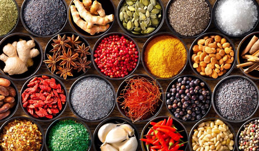 Colourful background from various herbs and spices for cooking in bowls. Top view